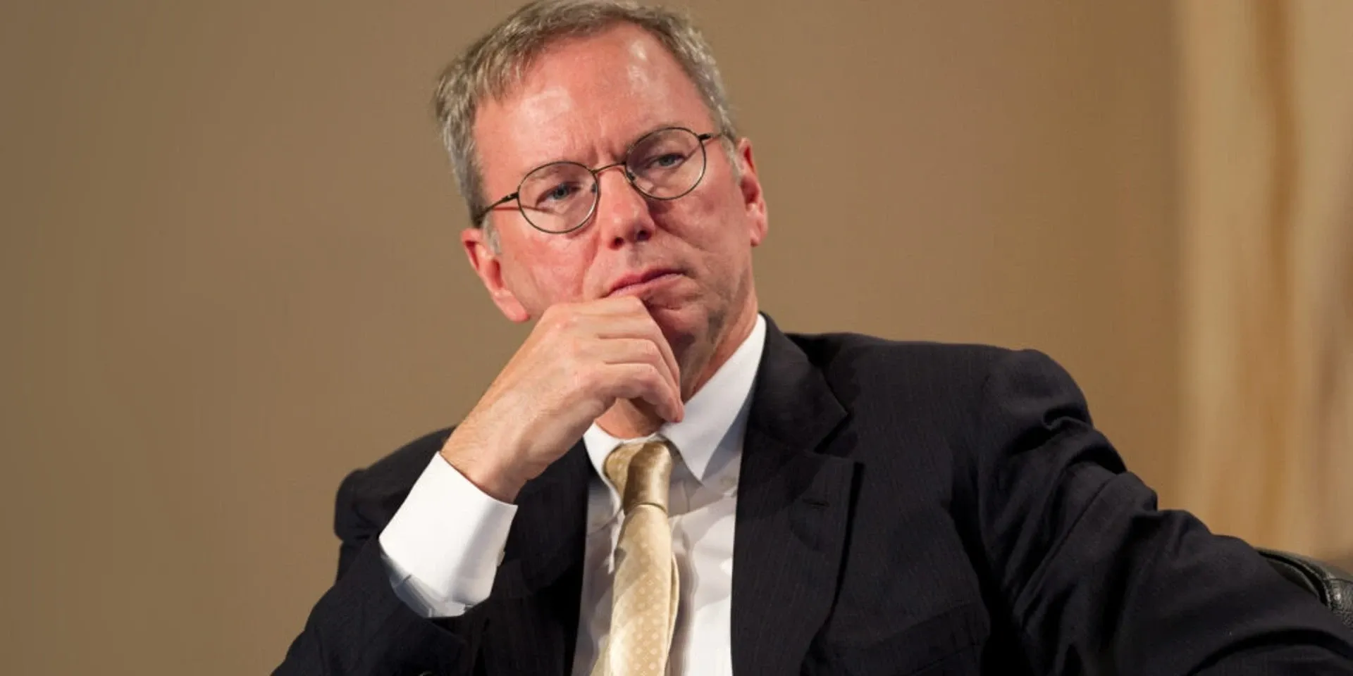 Eric Schmidt, former Google chief executive, seated with his hand on his chin