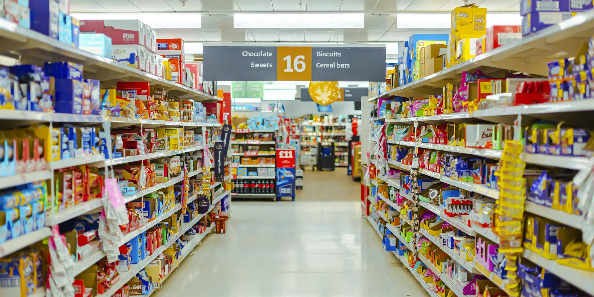 Supermarket aisle with shelf signage