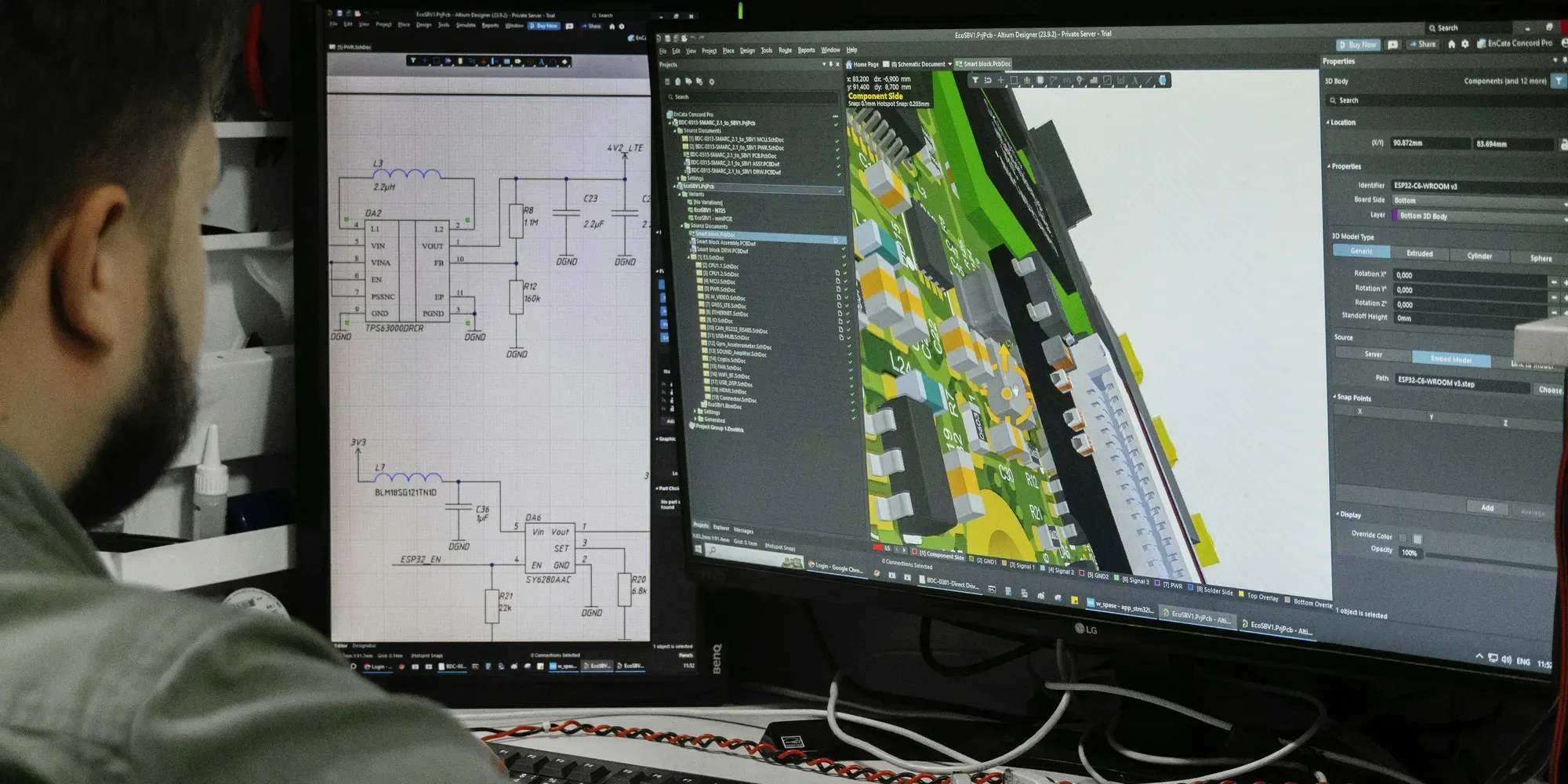 Engineer working on a circuit board design across two monitors
