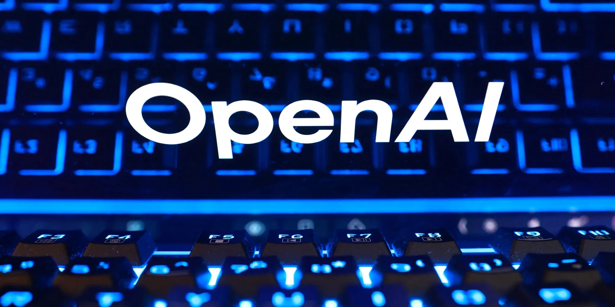 OpenAI logo over a backlit keyboard