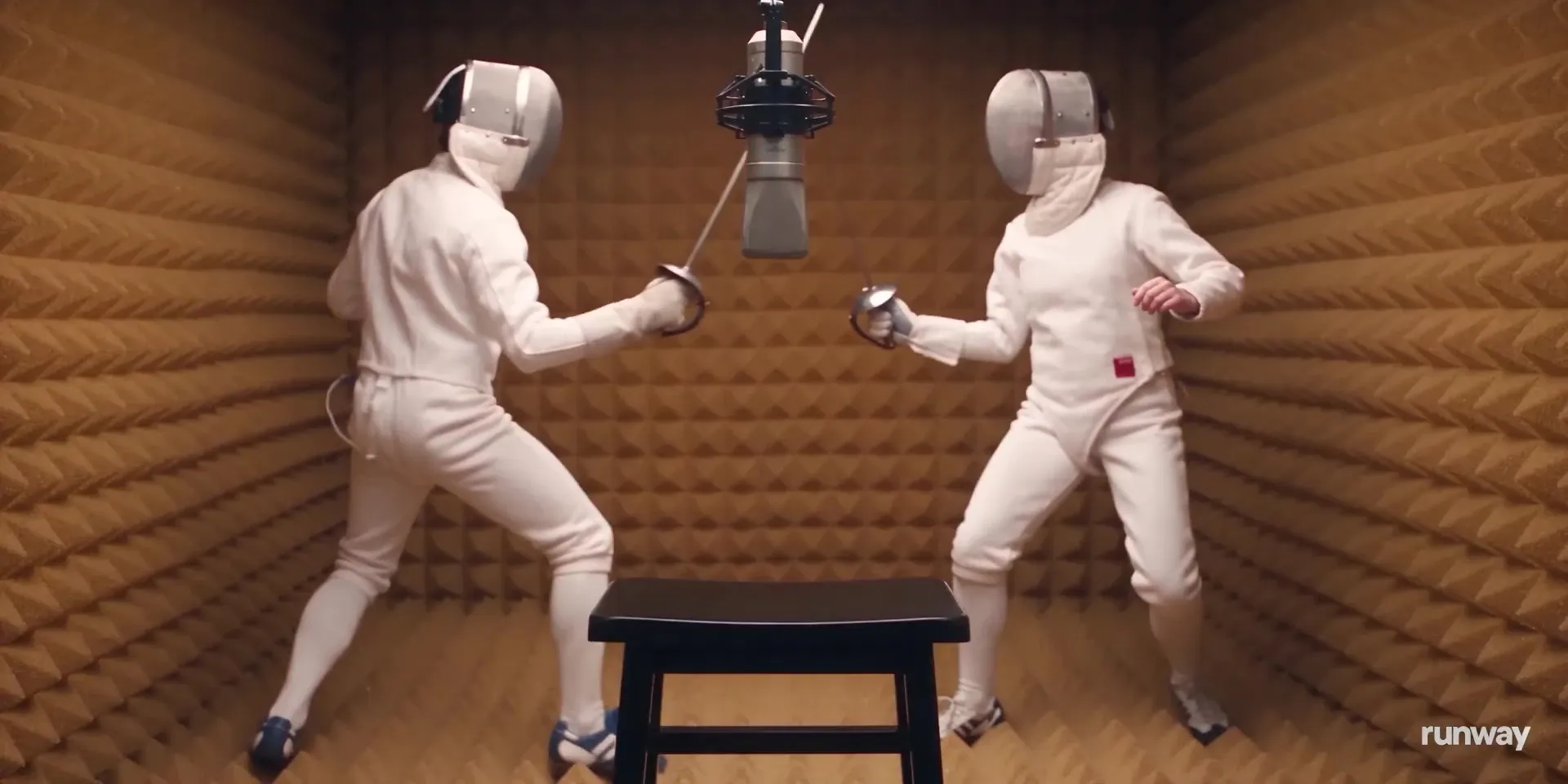 Two fencers in a foam-lined sound booth under a studio microphone, from Runway's Mirelo SFX launch video
